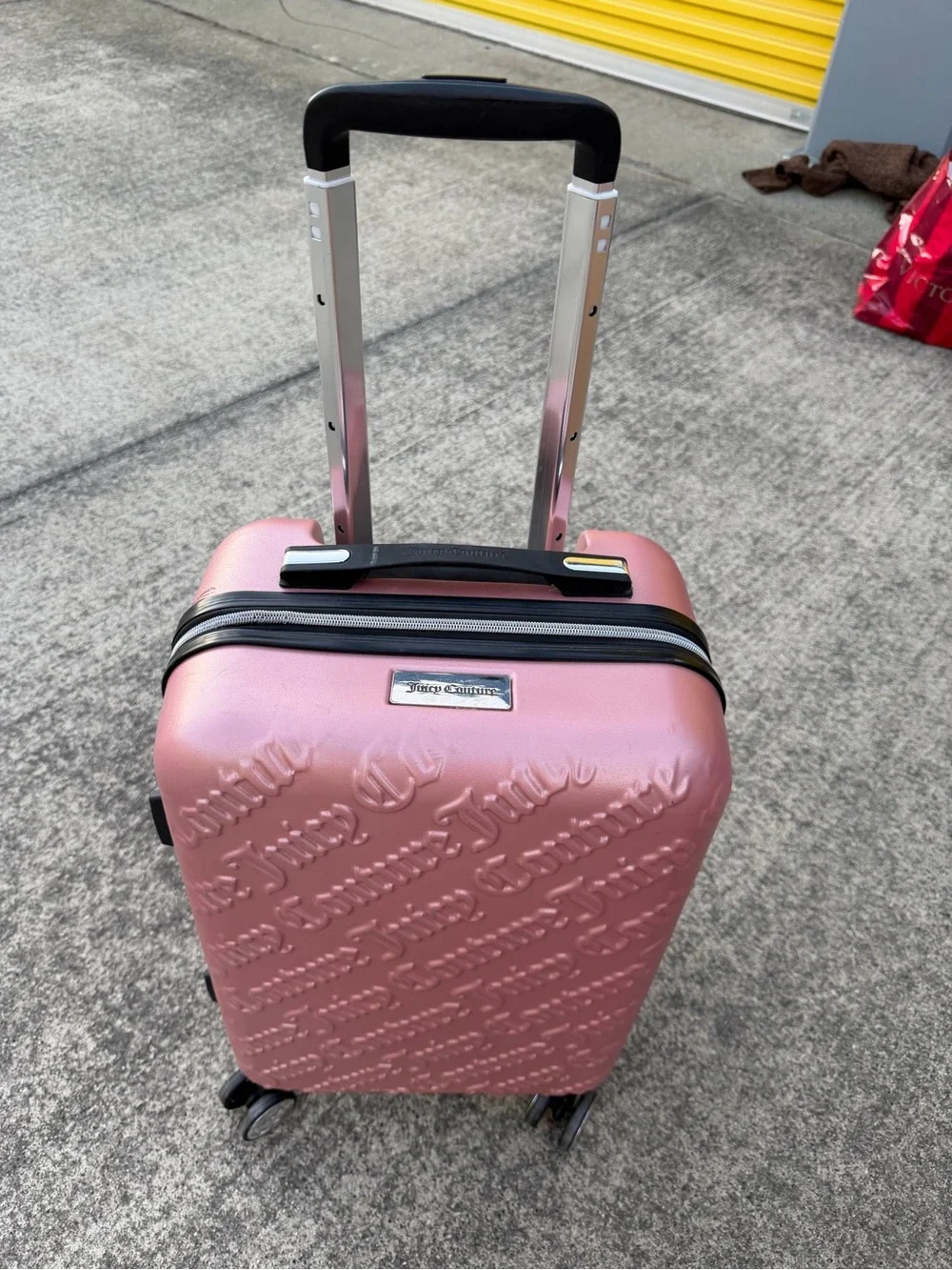 Juicy Couture spinner Suitcase in Rose Metallic with Embossed Logo